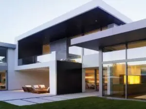 Modern architecture house with glass walls, flat roof, and minimalist geometric design.