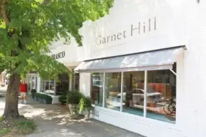 Garnet Hill store exterior with white brick facade and large shop windows on a sunny day