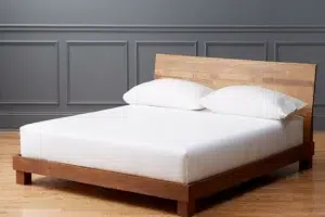 Modern bed frame with minimalist wooden design, white mattress, and clean contemporary bedroom interior.