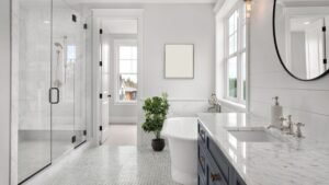 Modern bathroom renovation with glass shower, freestanding tub, and marble countertops