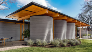 Modern House Pitcher design with 3D printed cylindrical walls and wooden roof in a contemporary home