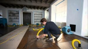 Professional Water Damage Restoration in progress with industrial drying equipment in a home interior