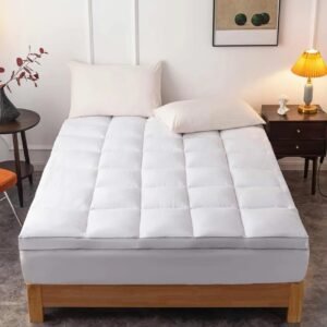 Soft white mattress with quilted top design placed on a wooden bed frame for comfortable sleep